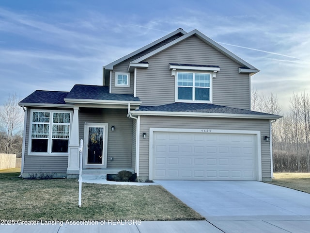 traditional home with a front lawn, a garage, and driveway