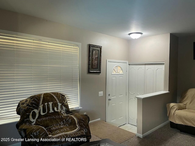 sitting room with baseboards and carpet floors