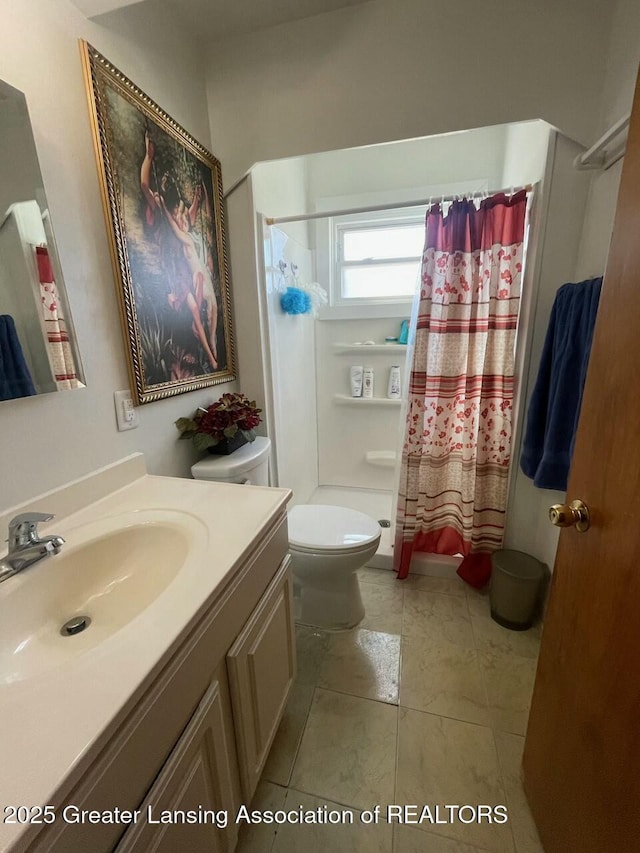 bathroom featuring curtained shower, toilet, and vanity