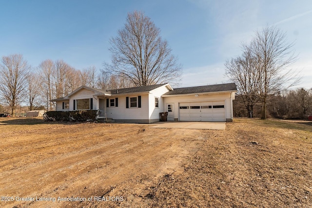 ranch-style home with an attached garage and dirt driveway