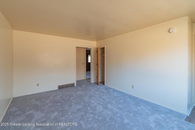 carpeted empty room with baseboards and visible vents