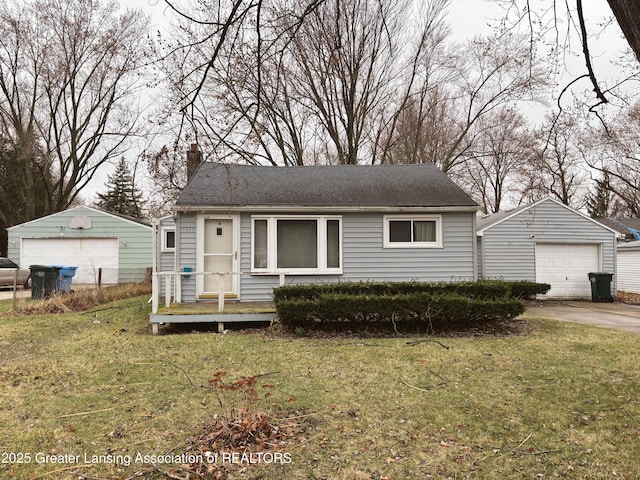 view of front of property with a garage, a chimney, an outdoor structure, and a front yard