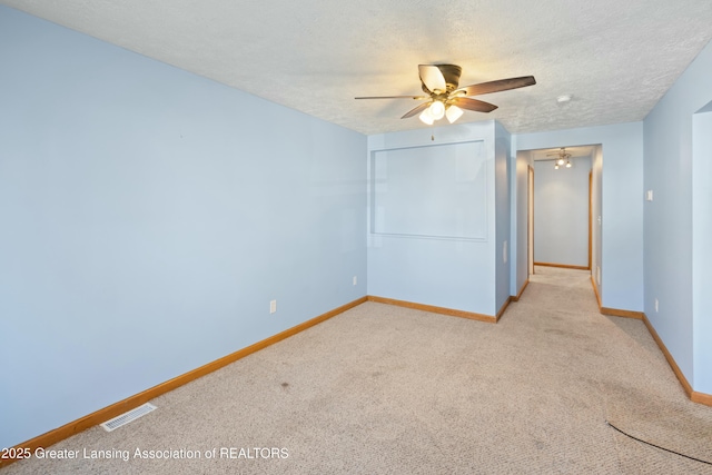 unfurnished bedroom with carpet, baseboards, a textured ceiling, visible vents, and a closet