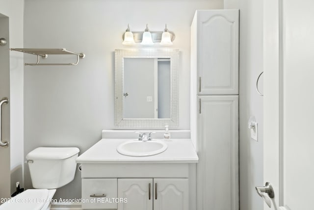 bathroom with toilet and vanity