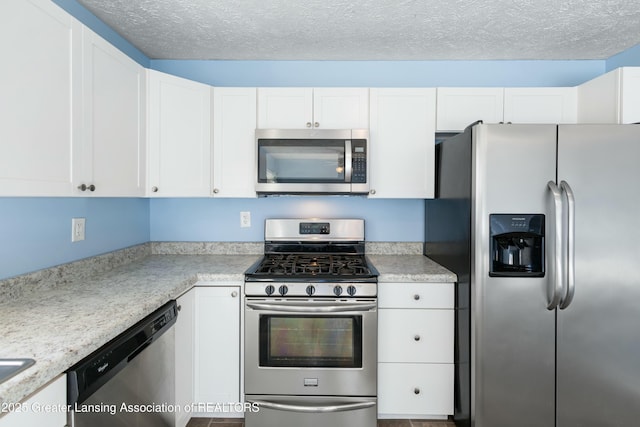 kitchen featuring white cabinetry, light countertops, and appliances with stainless steel finishes