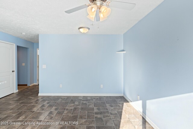 empty room featuring baseboards, ceiling fan, and a textured ceiling