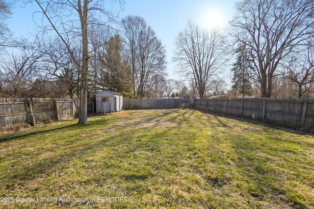 view of yard featuring a fenced backyard, an outdoor structure, and a shed