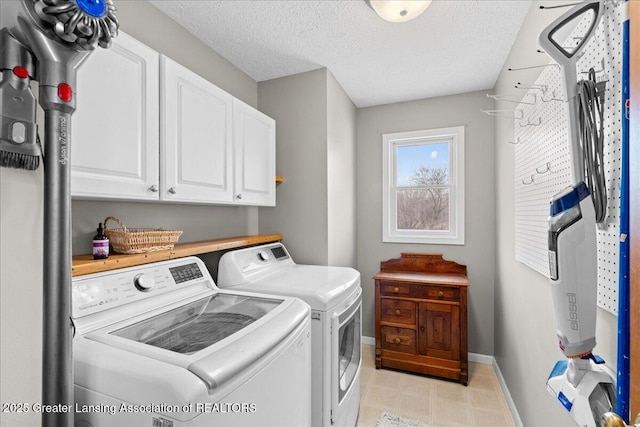 13305 Nelson, Bath, MI 48808 - laundry area with washer and dryer, a textured ceiling, baseboards, and cabinet space
