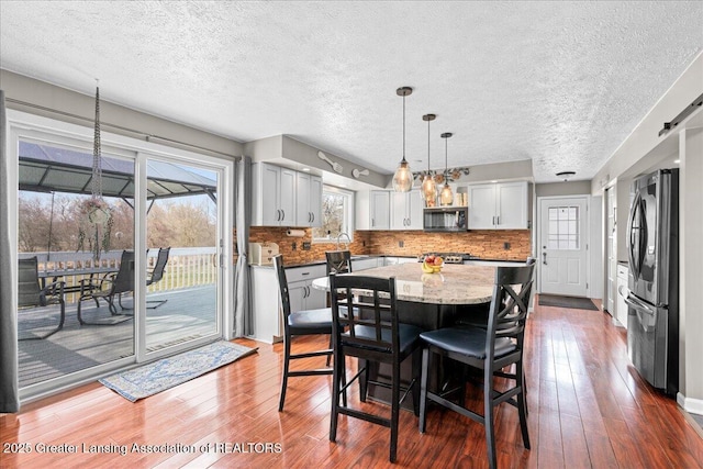 13305 Nelson, Bath, MI 48808 - dining space featuring hardwood / wood-style floors and a textured ceiling