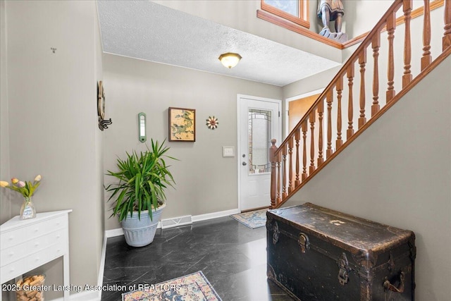 13305 Nelson, Bath, MI 48808 - foyer entrance featuring a textured ceiling, a healthy amount of sunlight, baseboards, and stairway