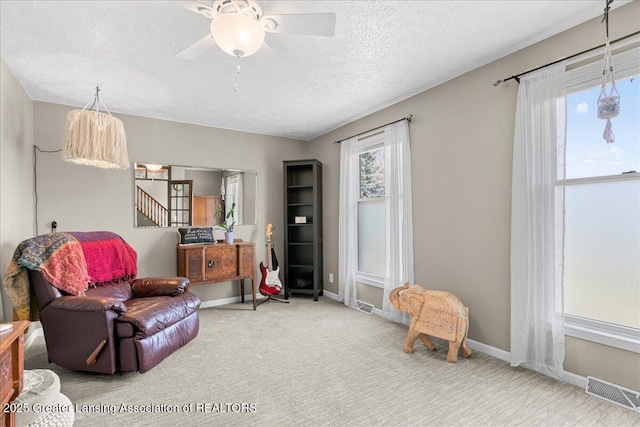 13305 Nelson, Bath, MI 48808 - living area featuring carpet, visible vents, a textured ceiling, and a ceiling fan