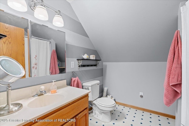 13305 Nelson, Bath, MI 48808 - bathroom with vanity, baseboards, vaulted ceiling, tile patterned floors, and toilet