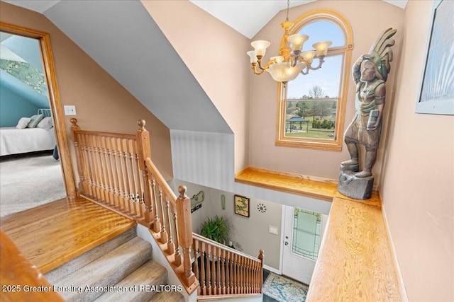 13305 Nelson, Bath, MI 48808 - stairway featuring a notable chandelier and vaulted ceiling