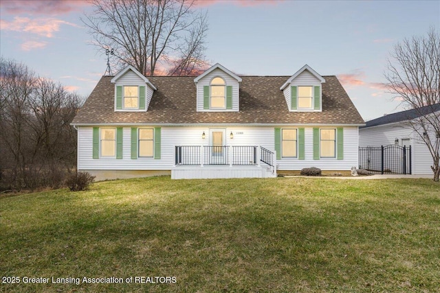 13305 Nelson, Bath, MI 48808 - back of property at dusk featuring a shingled roof and a lawn