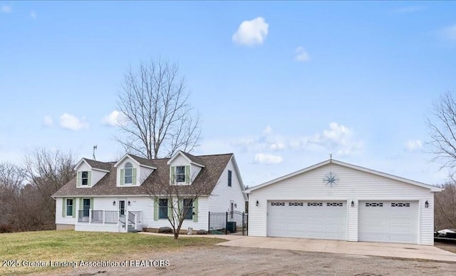 13305 Nelson, Bath, MI 48808 - cape cod house featuring a garage, a front lawn, and driveway