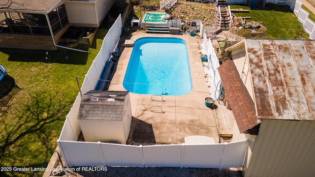 view of swimming pool featuring a fenced backyard, a fenced in pool, and a lawn
