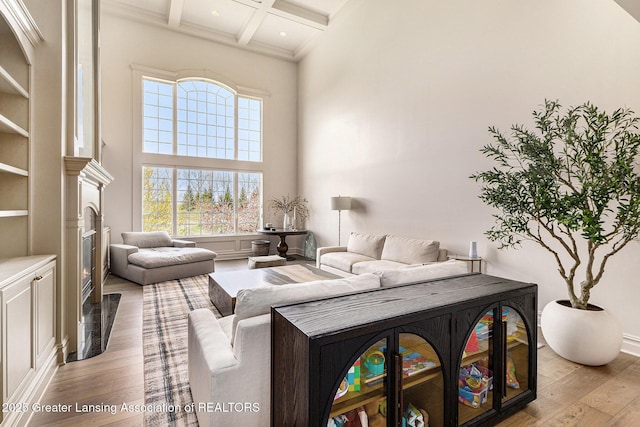 13600 Forest Hill Rd, Grand Ledge, MI 48837 - living area featuring light wood-type flooring, coffered ceiling, beam ceiling, a high ceiling, and recessed lighting