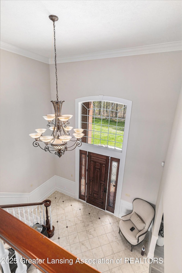 13600 Forest Hill Rd, Grand Ledge, MI 48837 - foyer entrance featuring a chandelier, crown molding, and baseboards