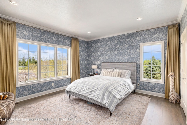 13600 Forest Hill Rd, Grand Ledge, MI 48837 - bedroom with wallpapered walls, crown molding, hardwood / wood-style flooring, baseboards, and recessed lighting