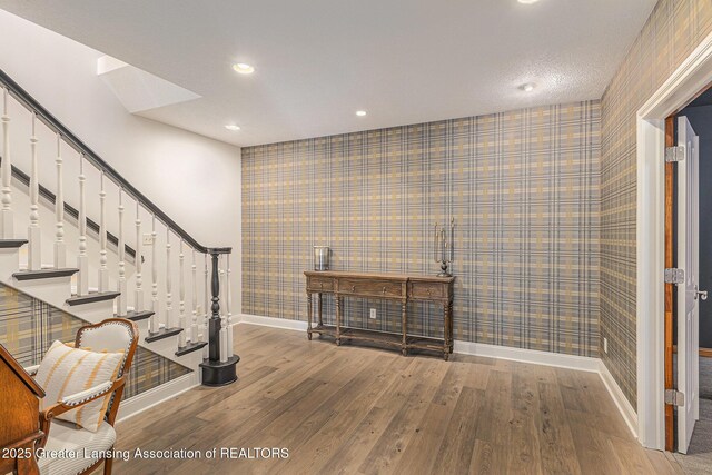 13600 Forest Hill Rd, Grand Ledge, MI 48837 - staircase featuring wallpapered walls, baseboards, wood finished floors, and recessed lighting