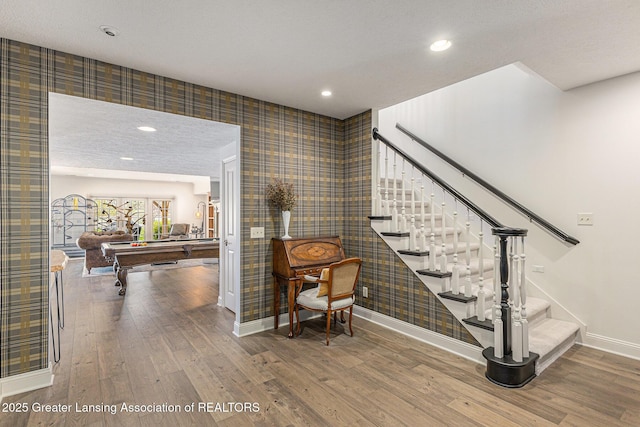 13600 Forest Hill Rd, Grand Ledge, MI 48837 - stairway with billiards, wood finished floors, baseboards, wallpapered walls, and recessed lighting