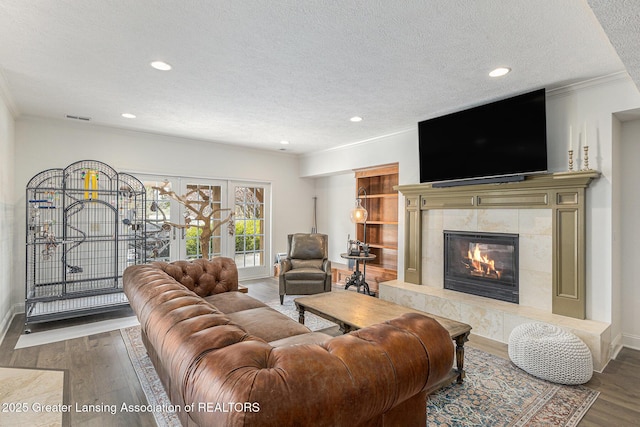 13600 Forest Hill Rd, Grand Ledge, MI 48837 - living room featuring a textured ceiling, wood finished floors, a fireplace, recessed lighting, and baseboards