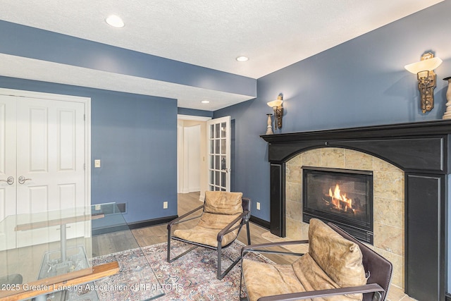 13600 Forest Hill Rd, Grand Ledge, MI 48837 - living room featuring wood finished floors, a fireplace, baseboards, recessed lighting, and a textured ceiling