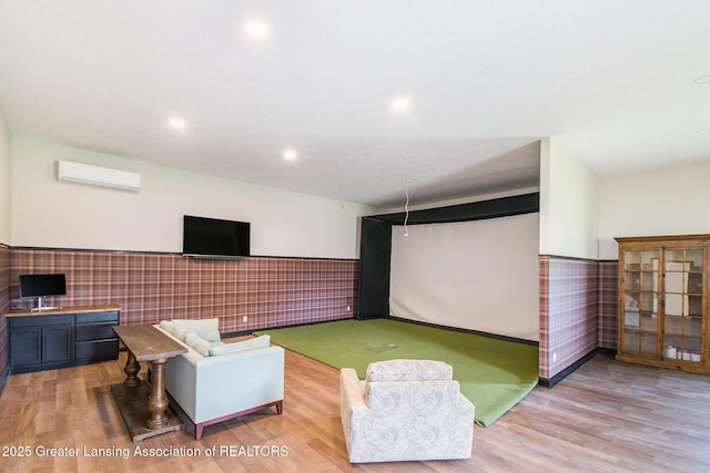 13600 Forest Hill Rd, Grand Ledge, MI 48837 - recreation room featuring golf simulator, a wall mounted air conditioner, a wainscoted wall, light wood-type flooring, and recessed lighting