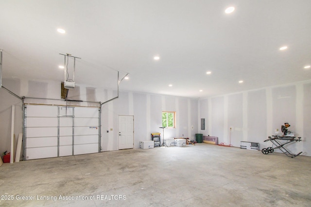 13600 Forest Hill Rd, Grand Ledge, MI 48837 - garage with a garage door opener, recessed lighting, and electric panel