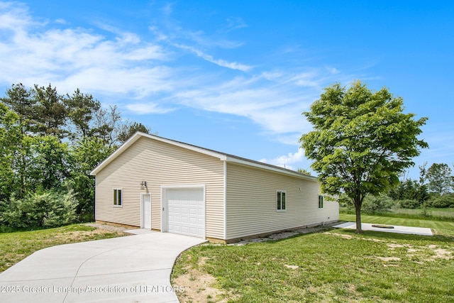 13600 Forest Hill Rd, Grand Ledge, MI 48837 - view of home's exterior with a lawn, concrete driveway, a detached garage, and an outbuilding