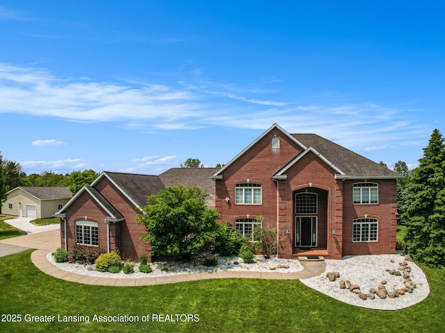 13600 Forest Hill Rd, Grand Ledge, MI 48837 - traditional-style house with brick siding and a front lawn