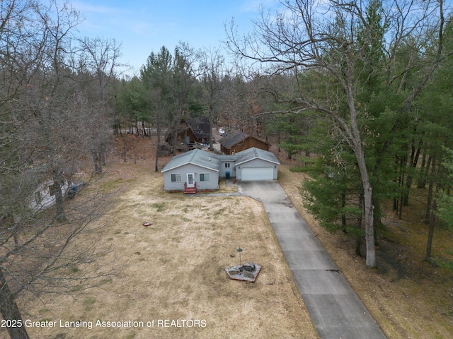 birds eye view of property featuring a view of trees