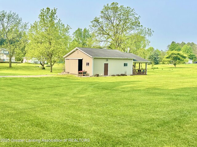 8464 W Howe Rd, Eagle, MI 48822 - view of pole building with a yard