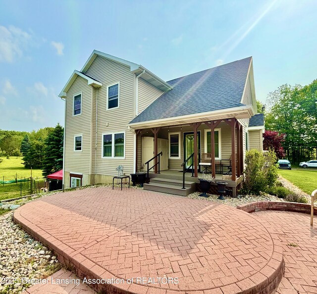 8464 W Howe Rd, Eagle, MI 48822 - back of house featuring covered porch and a shingled roof