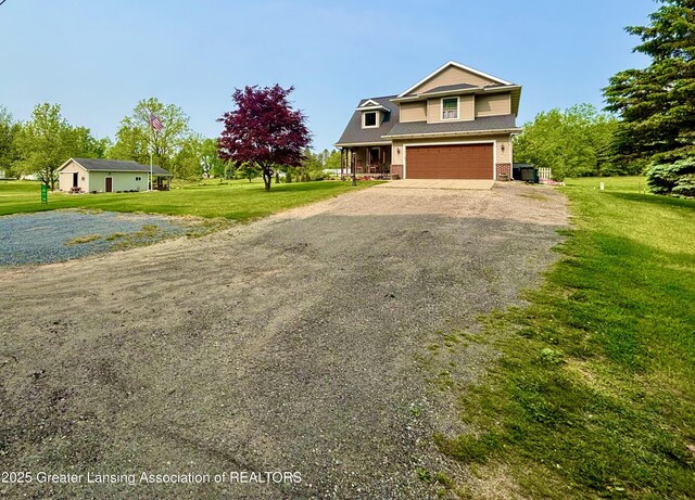 8464 W Howe Rd, Eagle, MI 48822 - view of front of house featuring driveway, an attached garage, a front yard, and brick siding