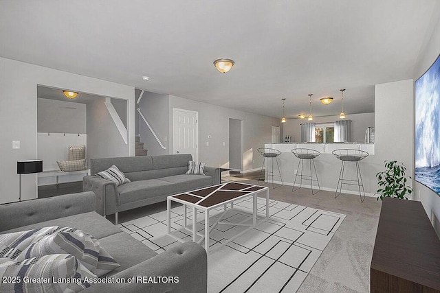 3012 Moccasin Dr, Dewitt, MI 48820 - living room featuring baseboards, light colored carpet, and stairway