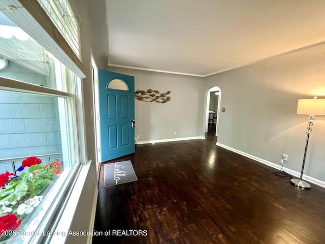 909 Britten Ave, Lansing, MI 48910 - foyer entrance with arched walkways, wood finished floors, baseboards, and crown molding