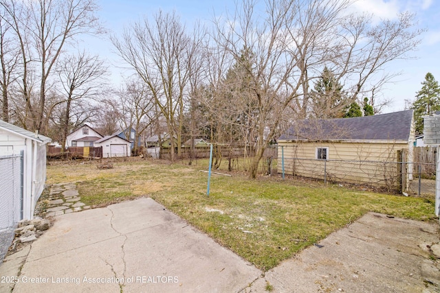 view of yard featuring an outbuilding, fence, and a patio area