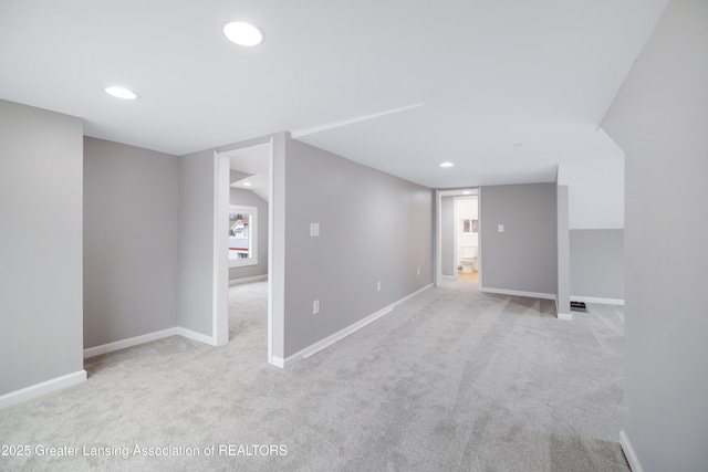 below grade area with carpet flooring, visible vents, baseboards, and recessed lighting
