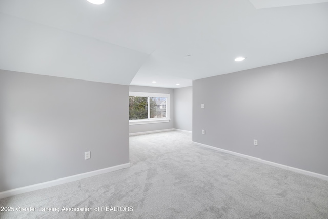 carpeted spare room featuring baseboards and recessed lighting