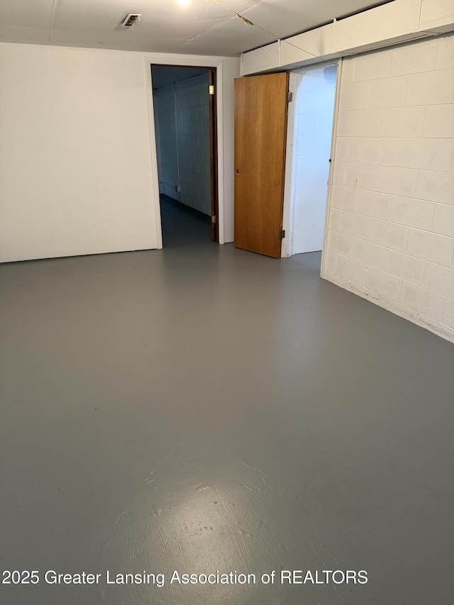 831 Jackson St, Eaton Rapids, MI 48827 - spare room featuring concrete floors and concrete block wall