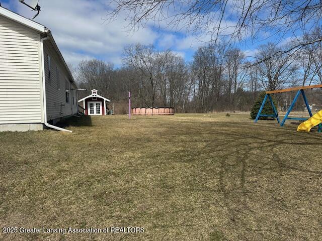 464 N Rolland Rd, Weidman, MI 48893 - view of yard featuring french doors and a playground