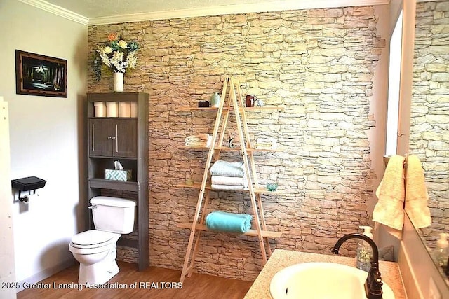 464 N Rolland Rd, Weidman, MI 48893 - bathroom featuring toilet, crown molding, wood finished floors, and a sink