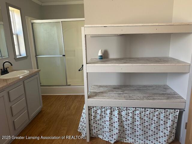 464 N Rolland Rd, Weidman, MI 48893 - full bathroom featuring a shower stall, wood finished floors, ornamental molding, and vanity