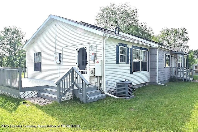 464 N Rolland Rd, Weidman, MI 48893 - rear view of house with central AC unit and a lawn