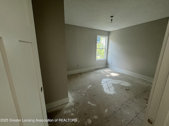 11350 Traverse Dr, Grand Ledge, MI 48837 - spare room featuring baseboards