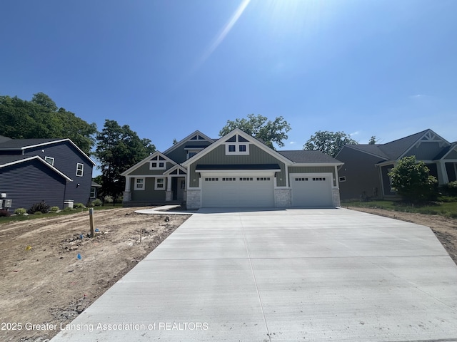11350 Traverse Dr, Grand Ledge, MI 48837 - craftsman-style home with an attached garage, concrete driveway, stone siding, and board and batten siding