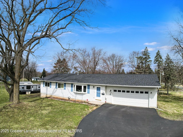 view of front of property featuring a front lawn, driveway, an attached garage, and roof with shingles