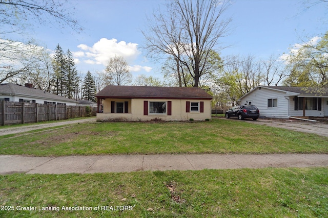 bungalow-style home with fence, stucco siding, and a front lawn