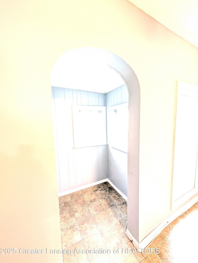 interior space featuring arched walkways and baseboards